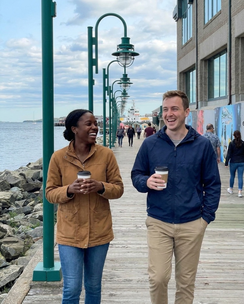 Friends with coffee on the waterfront boardwalk